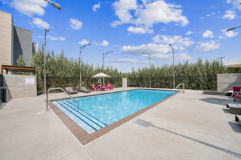 Outdoor pool with sundeck and lounge chairs